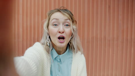 woman taking a selfie, excited expression