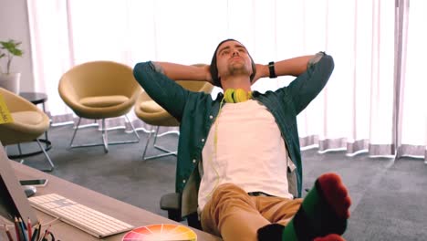 businessman relaxing with legs on desk