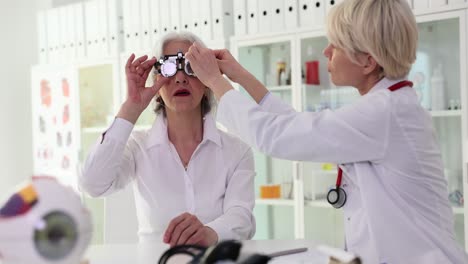 elderly woman undergoing eye exam with optometrist