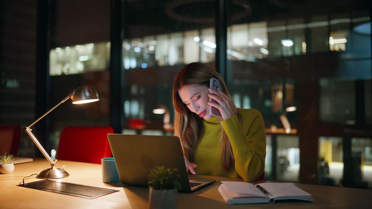 Businesswoman talking cellphone dark office closeup. Smiling woman calling phone