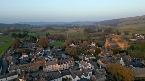 Aerial-footage-of-the-Medieval-village-of-Cartmel-in-the-English-Lake-District-it-has-a-rich-heritage,-and-varied-list-of-activities-for-visitors-and-tourists