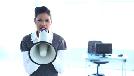 Serious-businesswoman-screaming-in-a-megaphone