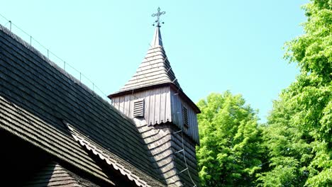 view of famous cross and steeple on top of wooden polish church on st