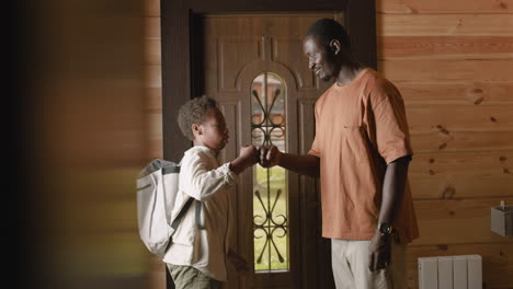 niño saludando a su papá y luego saliendo a la escuela mientras su padre se queda en casa y cierra la puerta