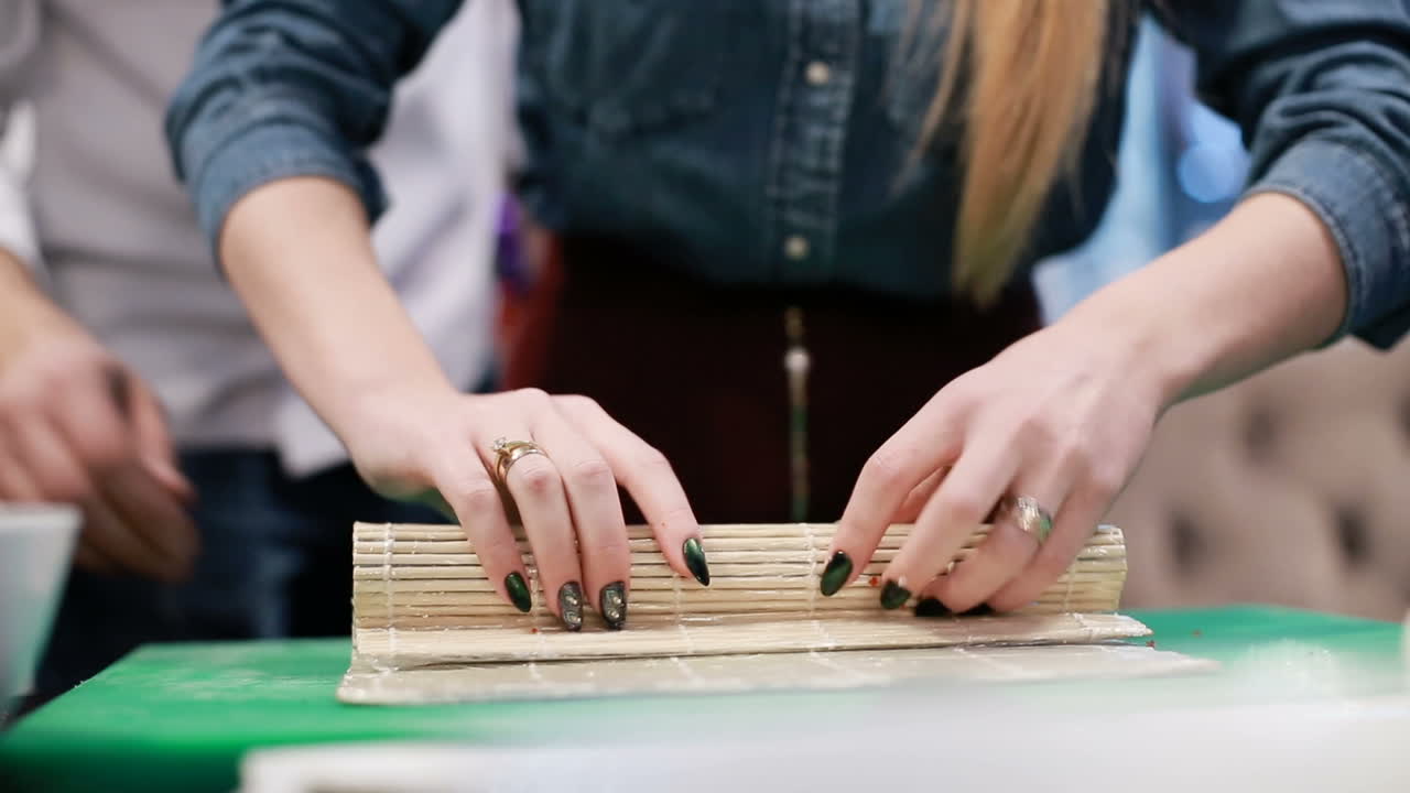 Making Salmon Sushi, Japanese Food. Chef is neatly cutting on fine part of salmon to make sushi