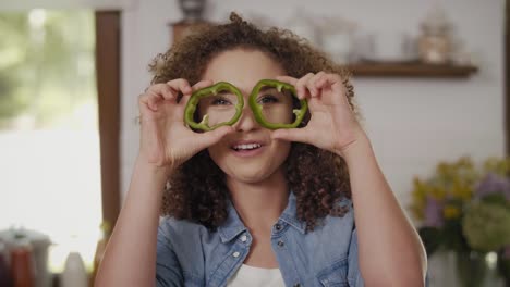 Young-woman-having-fun-with-pepper-in-the-kitchen/Rzeszow/Poland