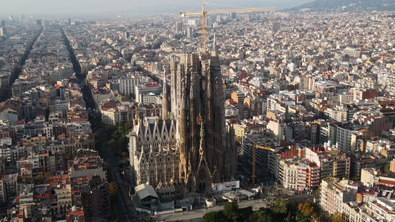 Aerial drone view of Barcelona, Spain. Blocks with multiple residential buildings and Sagrada Familia