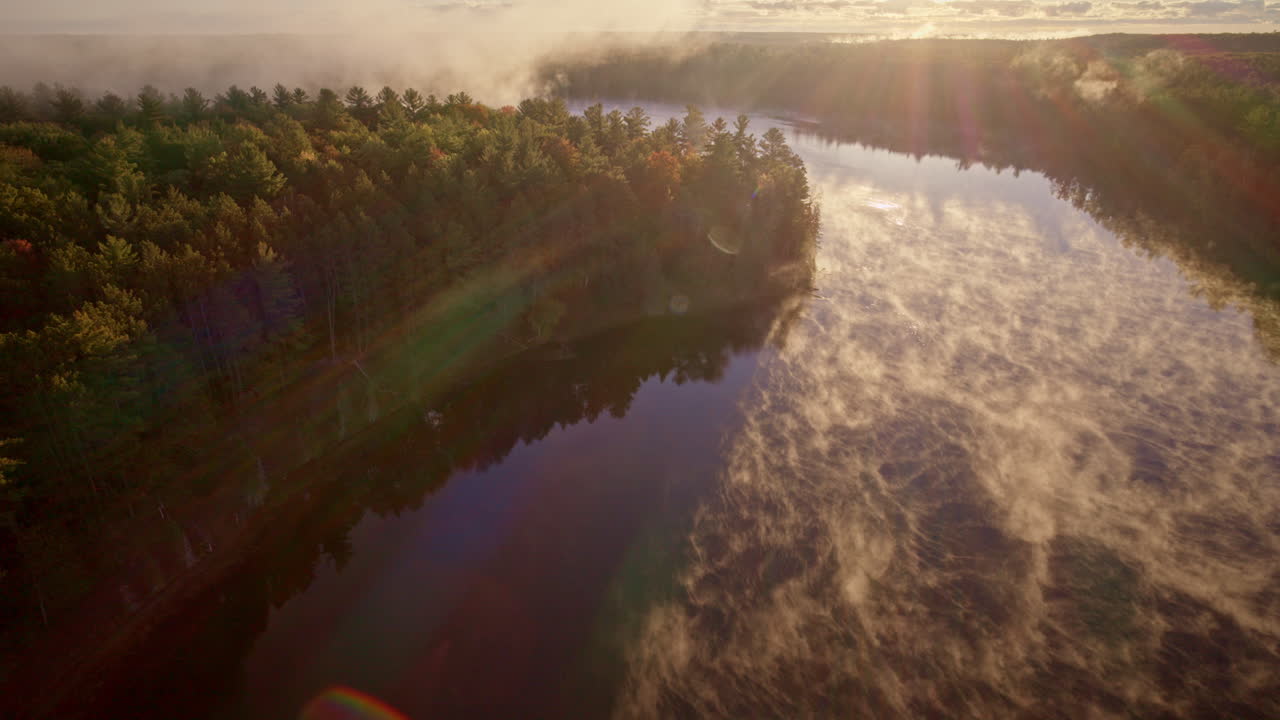 Drone shot revealing early morning vapor rising from water