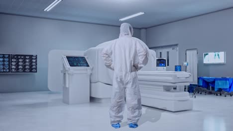 full body back view of asian male scientist putting hands on his hip and looking around with mri machine in the hospital