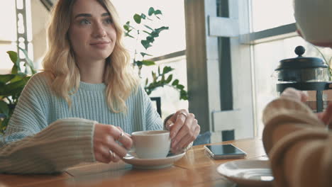 jóvenes amigas hablando y tomando una taza de té y un café 1