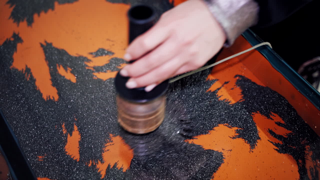 The boy at the science center. Iron powder under the influence of a magnetic field.