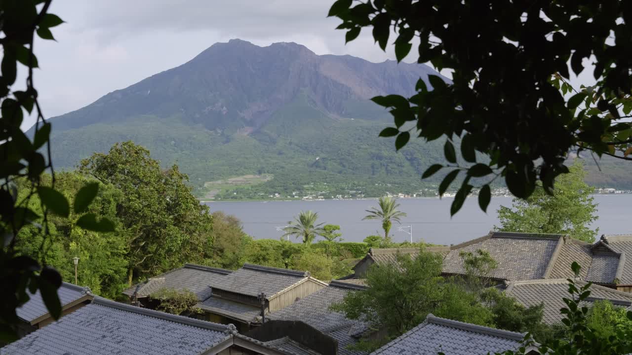 Typical Japanese houses with traditional architecture and Sakurajima in distance