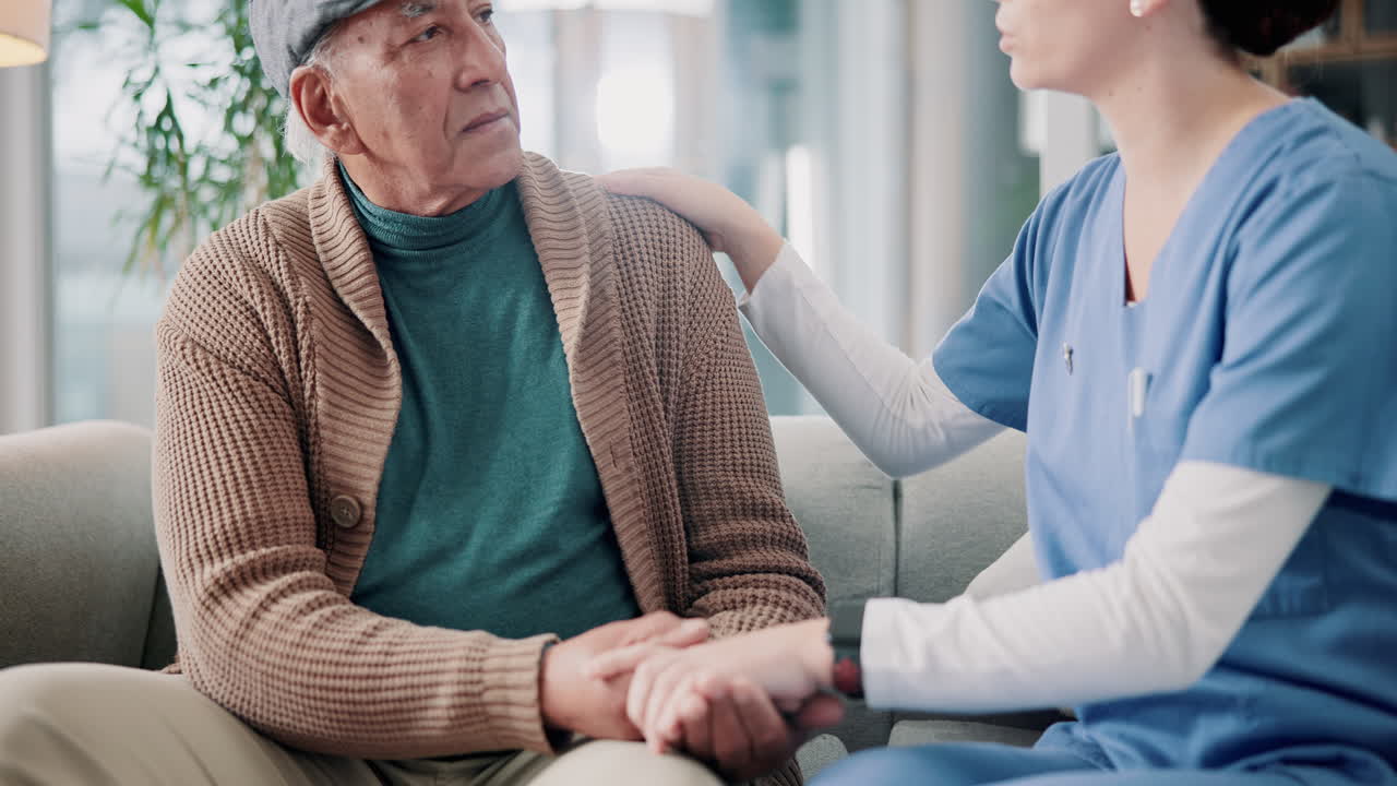 Nurse providing comfort and support to elderly man