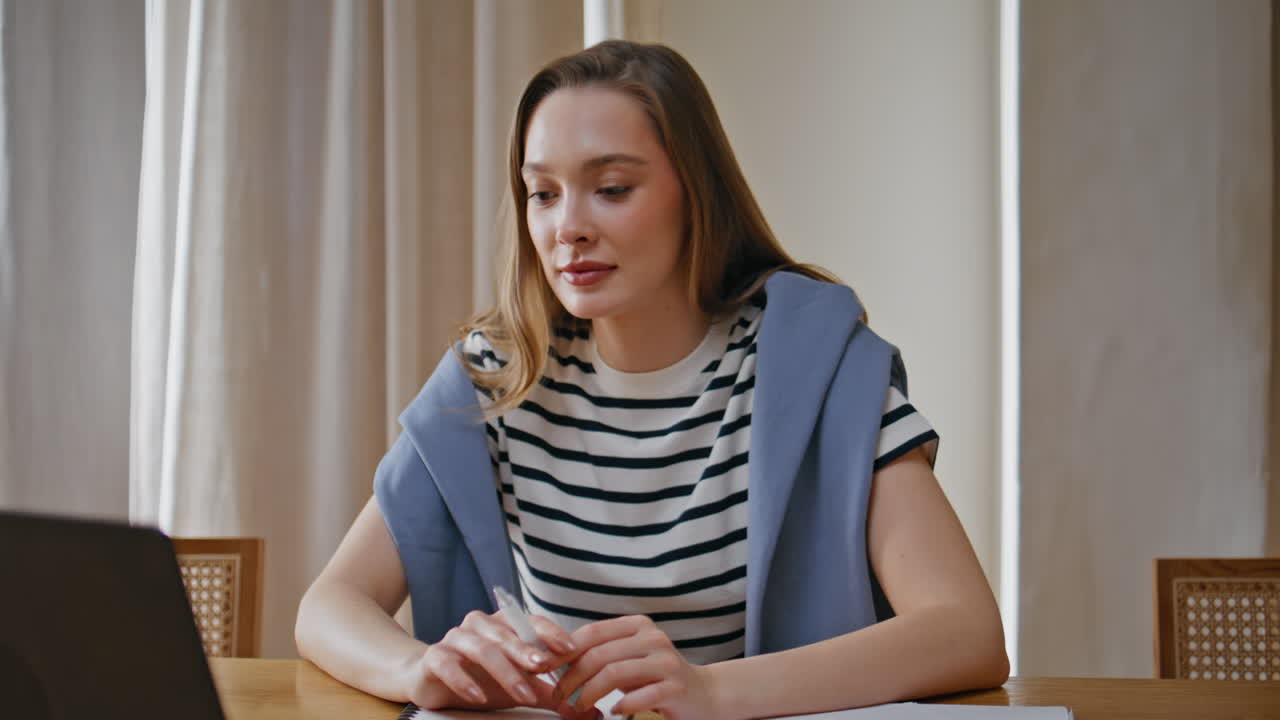 Online consultant talking laptop webcam sitting home workplace smiling closeup