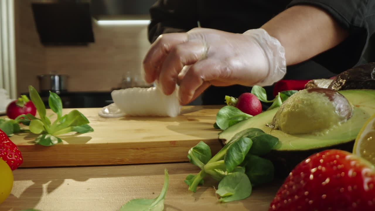 Close-up of hands preparing a healthy meal with fresh ingredients in a kitchen