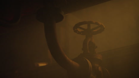 rusty valve in a dark industrial setting