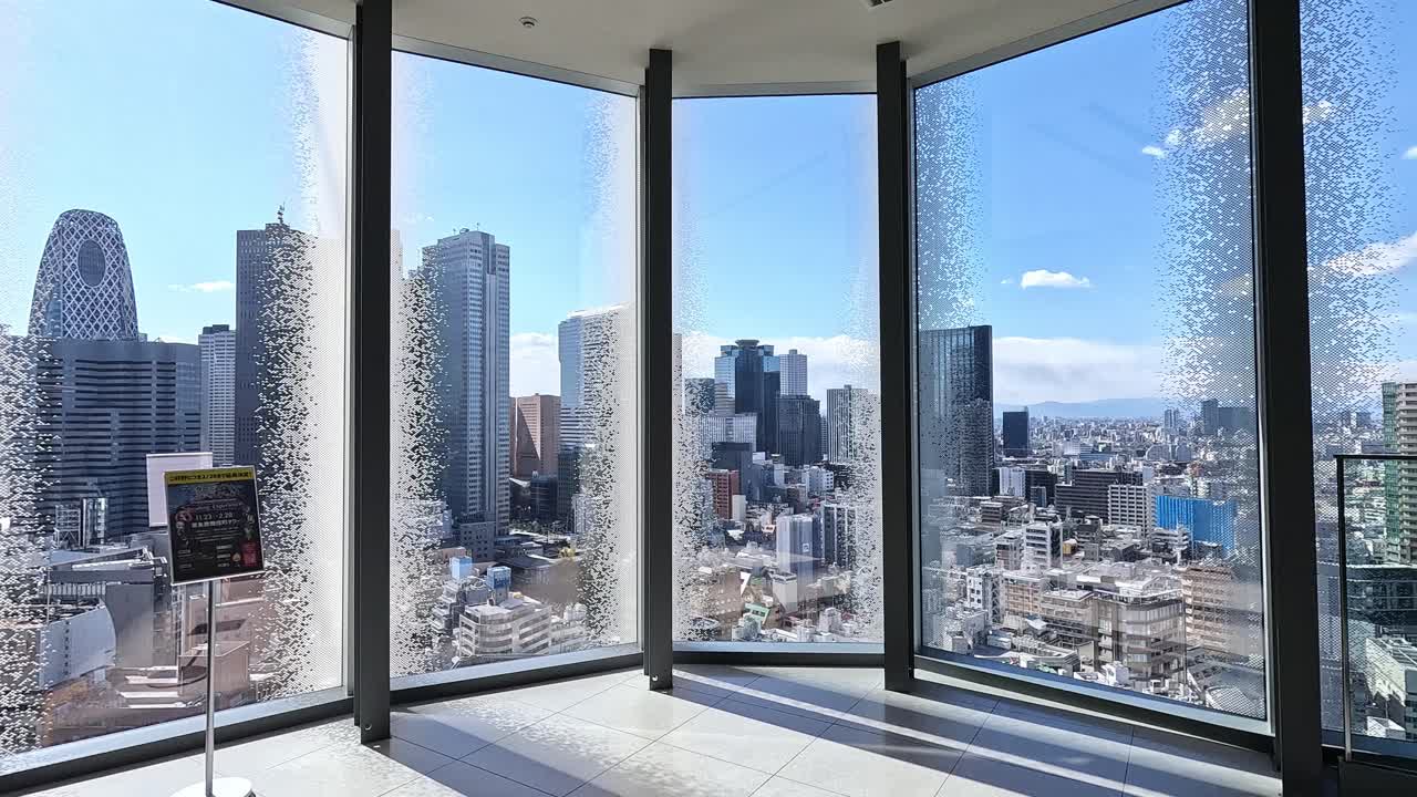 Wide Panoramic View of the Tokyo Skyline from the Upper Floors of Tokyu Kabukicho Tower Featuring Shinjuku’s Skyscrapers on a Clear Sunny Day