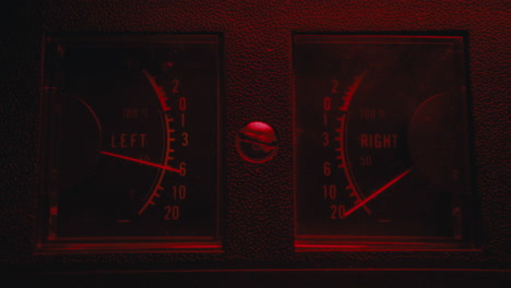 a close-up on a vintage tape recorder in a red blinking light