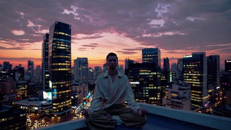 young man practicing yoga and meditating in lotus position on a rooftop at sunset, with the skyline of tel aviv in the background, finding peace and balance amidst urban chaos