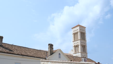 view of hvar cathedral's 17th-century bell tower against bright sunny sky in croatia