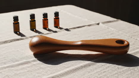 wooden massage tool and essential oils