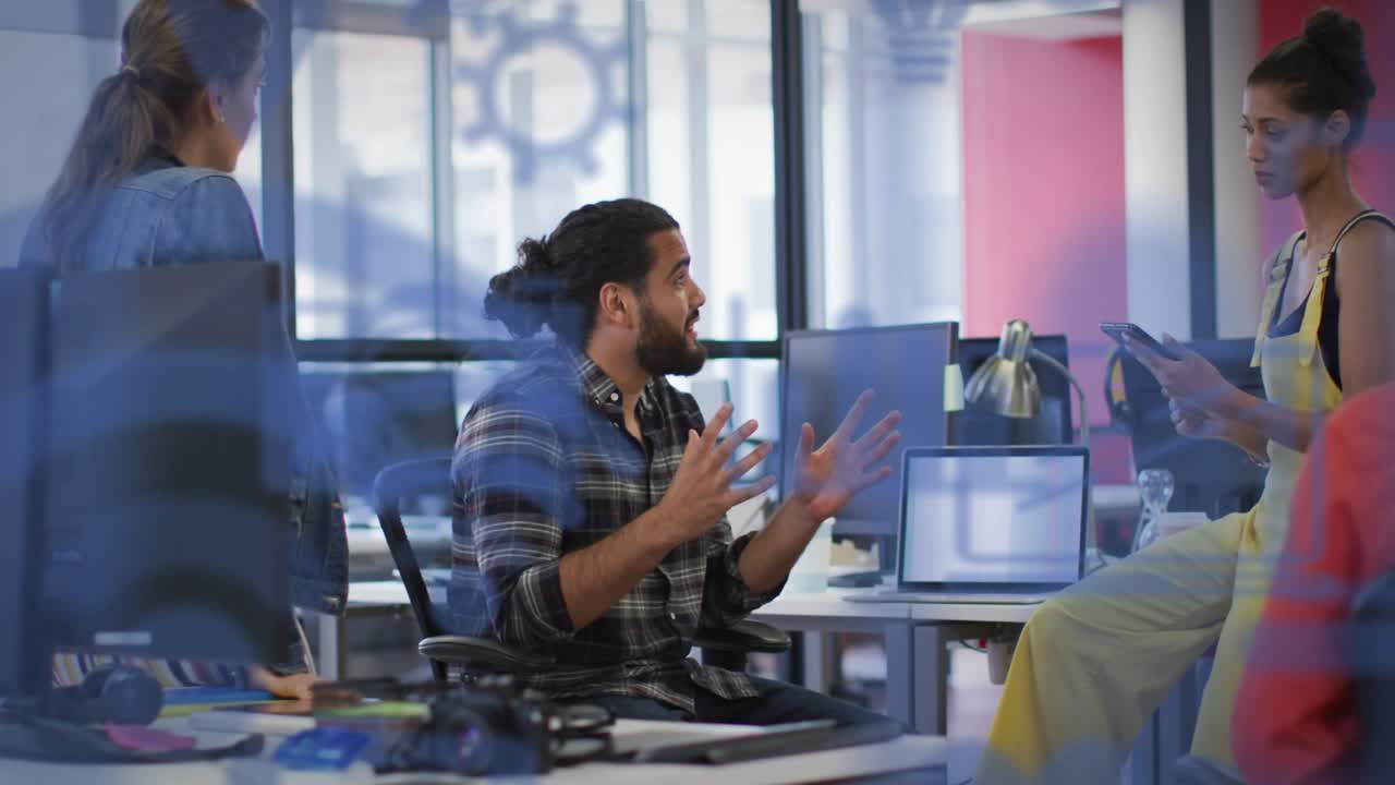 Seated man gesturing, woman tapping tablet, getting replies while business team checking plan