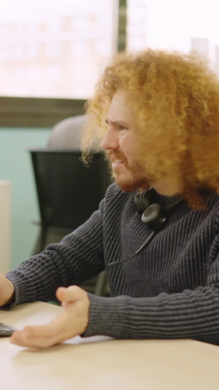 Angry worker experiencing computer problems in a coworking