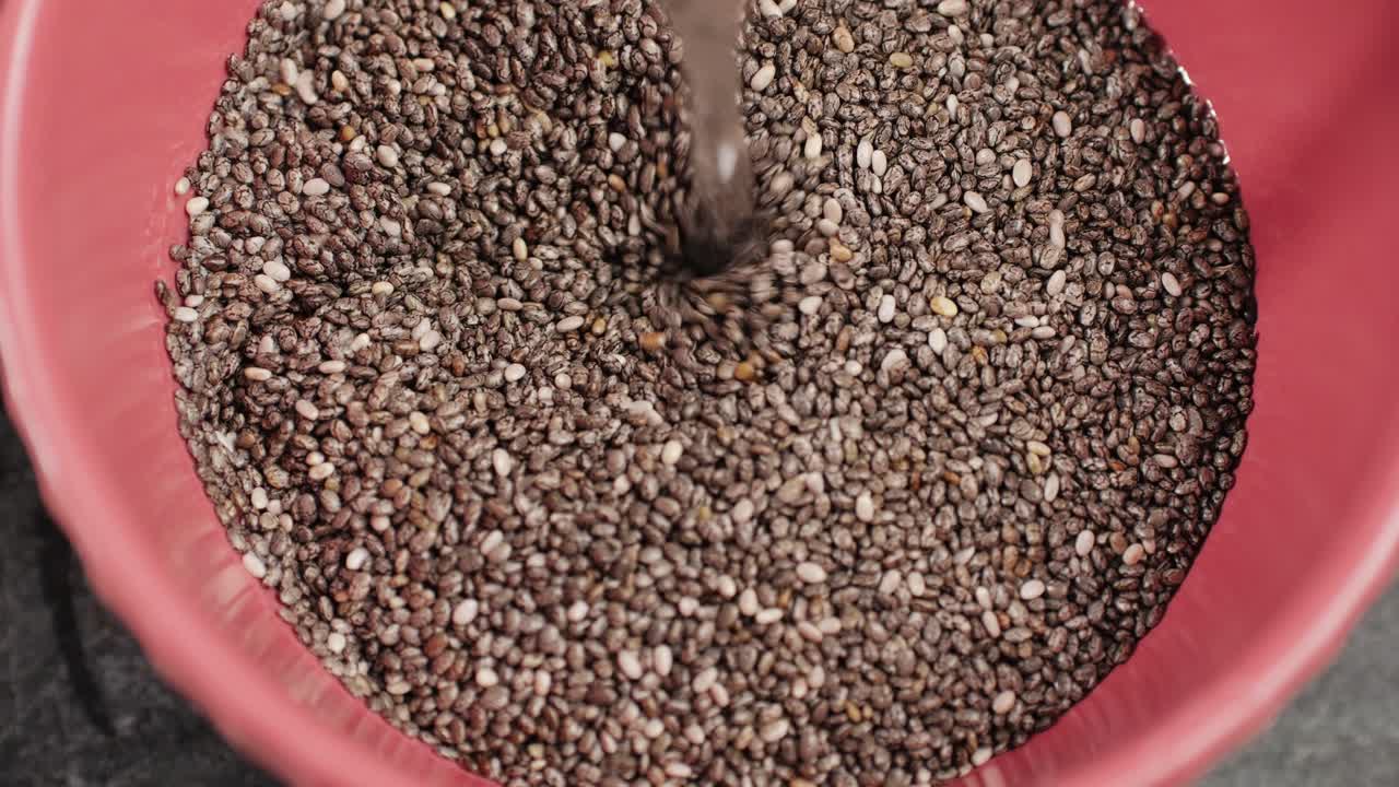 Chia seeds close-up macro. Dry healthy ingredient. Healthy superfood rich in Omega 3 fatty acids. Salvia hispanica. High quality 4k footage