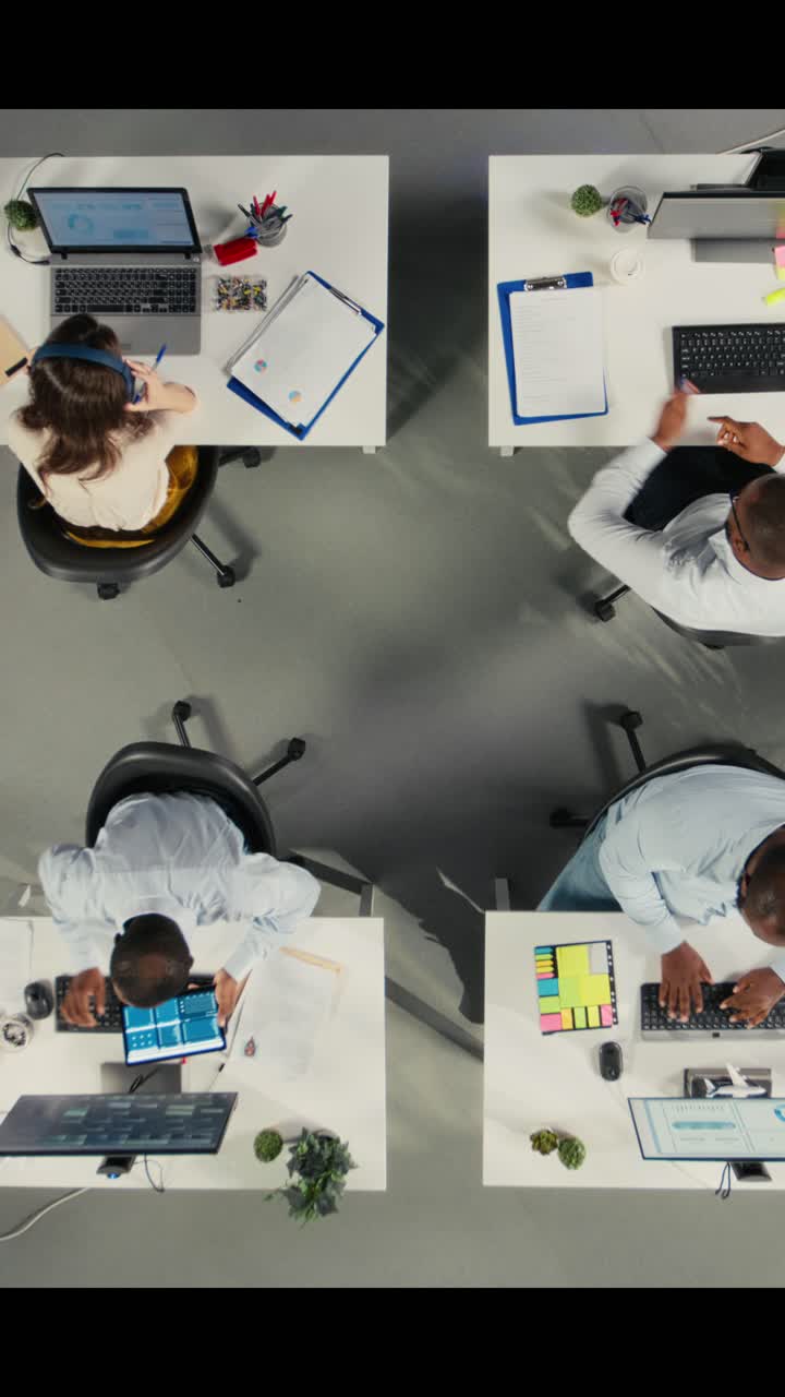 Vertical Video Top down view of colleagues in multinational company office discuss strategy