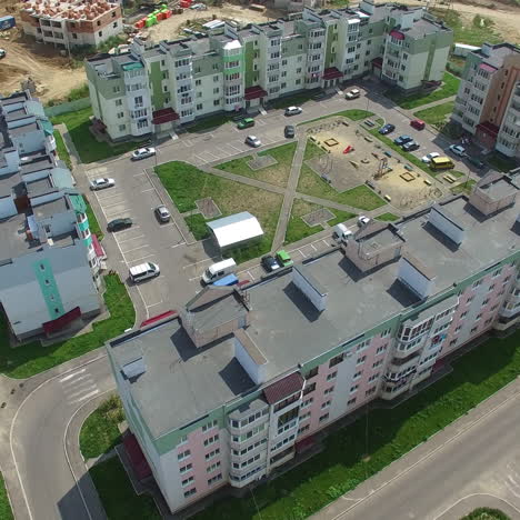 flying forward over the new colorful buildings recently built in the residential area in the city. nicely planned architectural buildings during the sunny day.