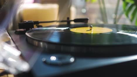 Guy-Putting-a-Vinyl-on-a-Record-Player-at-Home-in-the-Morning