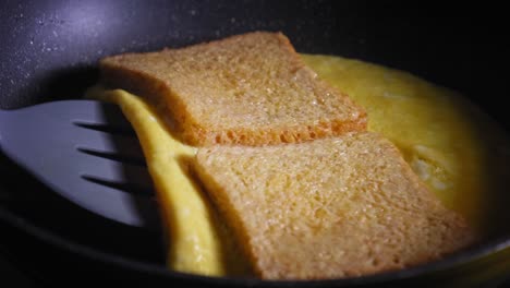 making egg and cheese toast in pan folding it together and letting it cook