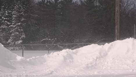 blowing snow creates a mesmerizing scene over the snowbanks in canada, capturing the essence of a cold and windy winter day in the great white north
