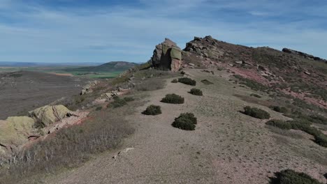 Aerial-drone-approaching-view-of-an-enigmatic-red-sandstone-rocky-landscape-in-a-remote-mountainous-area-in-Guadalajara,-Spain