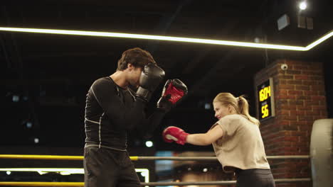 sporty athletes enjoying training in sport club. sport couple boxing at gym