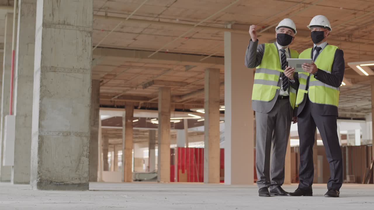 Architects Wearing Masks Using Tablet Computer