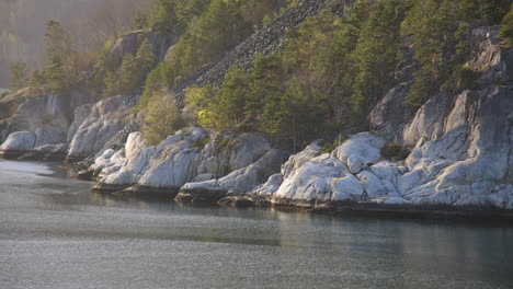 time lapse shot of rocks passing by on the eidfjorden, eldfjord