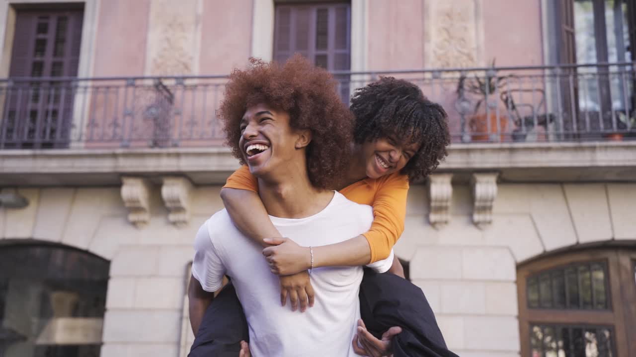 Happy ethnic young couple on street during daytime