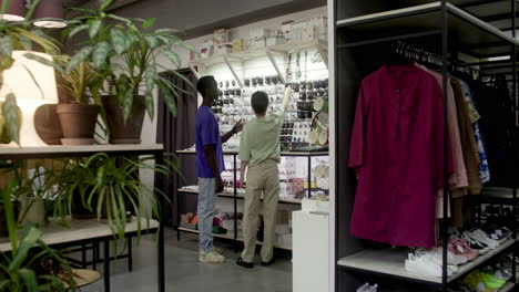 Young-man-and-saleswoman-walking-in-a-store