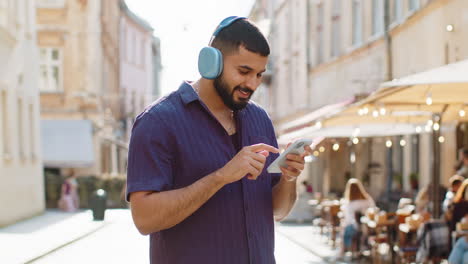 man using smartphone in city street