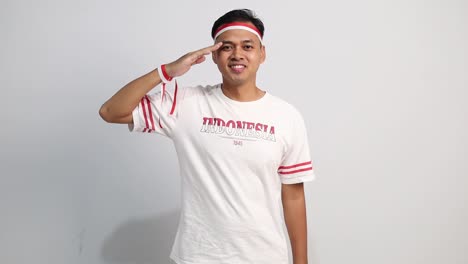handsome asian man giving salute celebrate indonesian independence day on 17 august isolated over white background