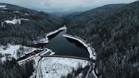 aerial shot around pas du riot dam and reservoir near saint etienne in pilat regional park during winter, loire departement, auvergne rhone alpes region, france