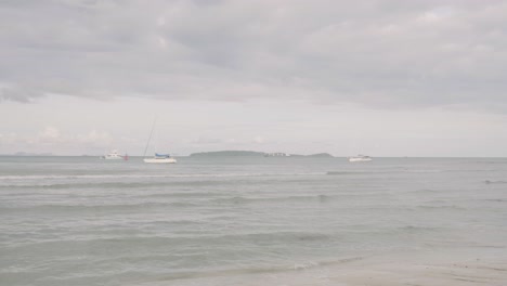 Ocean-waves-breaking-into-the-shore-on-the-beach-in-Phuket,-Thailand