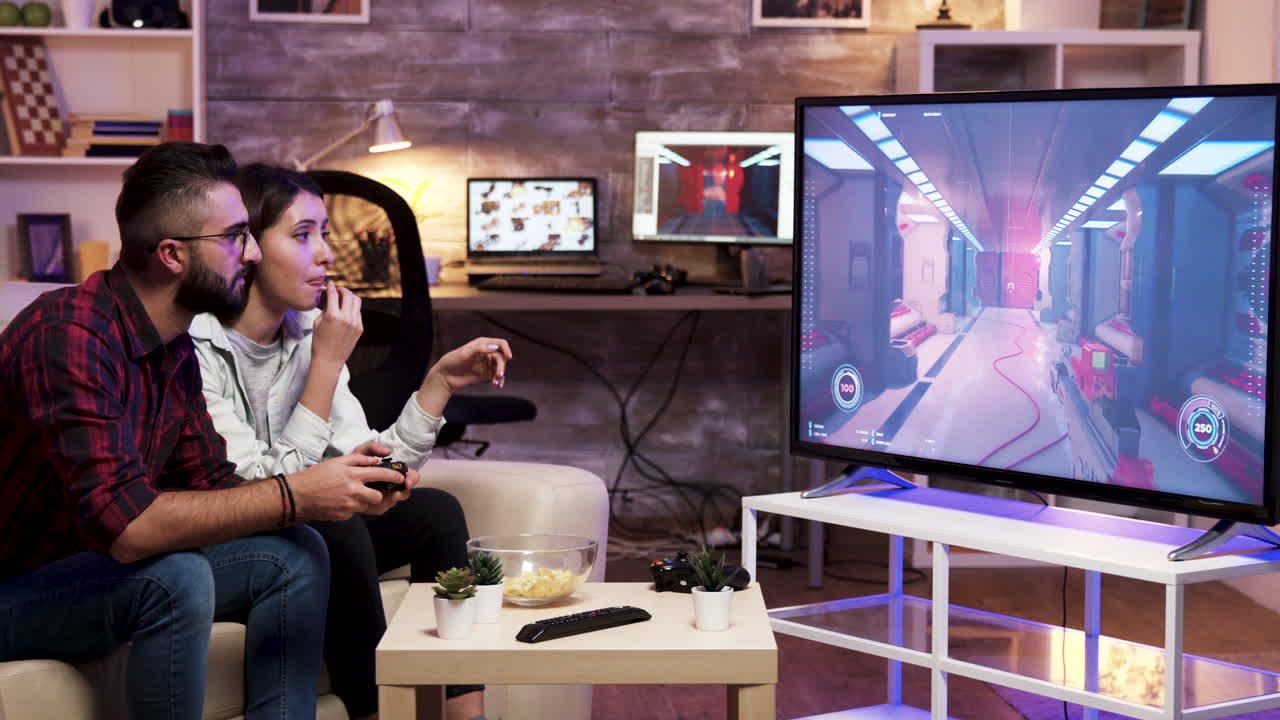 Couple playing video games in the living room