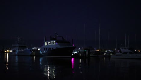 illuminated yachts docked at night harbor