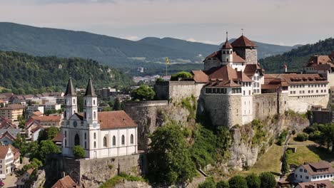 aerial of historic aarburg castle and white church perched above the aare river switzerland
