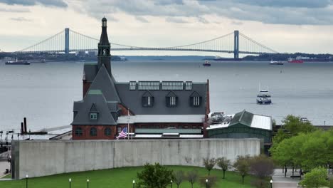 liberty state park at ellis island with usa american flag waving in breeze