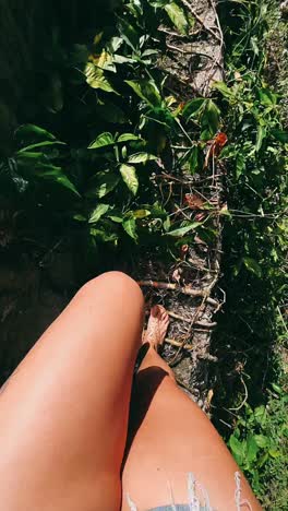 woman hiking through a lush jungle path