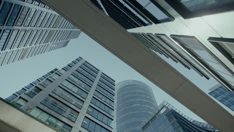 extreme low angle shot of tall office buildings during evening