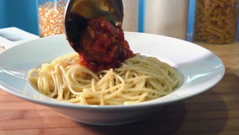 Adding-Fresh-Homemade-Meatballs-to-a-Bowl-of-Pasta